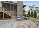 Spacious backyard with a large stone patio, screened porch, and beautifully landscaped yard at 2073 Amalfi Pl, Apex, NC 27502