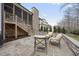 This stone patio features outdoor seating, a backyard view, and stairs leading to a porch at 2073 Amalfi Pl, Apex, NC 27502