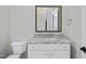 Bright bathroom with white cabinets, marble countertops, and modern fixtures at 2073 Amalfi Pl, Apex, NC 27502