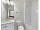 Bathroom with a tub and shower, a white vanity and toilet, and black and white tile at 2073 Amalfi Pl, Apex, NC 27502