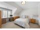 Bedroom with a desk area, ample storage, and a cozy bed beneath a sloped ceiling at 2073 Amalfi Pl, Apex, NC 27502