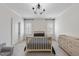 Cozy bedroom featuring natural light, chandelier, and wood furnishings at 2073 Amalfi Pl, Apex, NC 27502