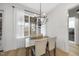 Elegant dining room featuring a wooden table, modern lighting, and sheer curtains at 2073 Amalfi Pl, Apex, NC 27502