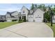 Lovely home with a long driveway leading to a three-car garage and a basketball hoop visible on the side at 2073 Amalfi Pl, Apex, NC 27502