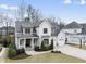 Beautiful two-story home featuring a three-car garage, landscaped front yard, and welcoming entrance at 2073 Amalfi Pl, Apex, NC 27502