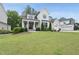 Attractive home with a lush green lawn, covered porch, and a visible three-car garage on the side at 2073 Amalfi Pl, Apex, NC 27502