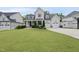 Charming two-story home featuring a manicured lawn, a two-car garage, and classic architectural details at 2073 Amalfi Pl, Apex, NC 27502