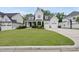Beautiful home with a well-manicured lawn, showcasing modern architecture and a three-car garage at 2073 Amalfi Pl, Apex, NC 27502