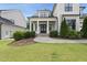 Charming home featuring a covered front porch with elegant columns and well-maintained landscaping at 2073 Amalfi Pl, Apex, NC 27502