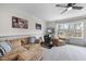Inviting game room features plush seating, a ceiling fan, and an arcade machine for entertainment at 2073 Amalfi Pl, Apex, NC 27502