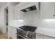Gourmet kitchen features stainless steel range and custom hood and backsplash at 2073 Amalfi Pl, Apex, NC 27502