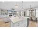 Kitchen island with seating and sink with views of the fireplace in the living room at 2073 Amalfi Pl, Apex, NC 27502