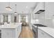 Bright eat-in kitchen with stainless steel appliances and range with custom backsplash at 2073 Amalfi Pl, Apex, NC 27502