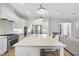 Bright kitchen with stainless steel appliances, an island with seating, and pendant lights at 2073 Amalfi Pl, Apex, NC 27502