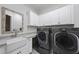 Convenient laundry room with stainless steel appliances and utility sink at 2073 Amalfi Pl, Apex, NC 27502