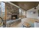 This covered back porch features a stone fireplace with a television and seating at 2073 Amalfi Pl, Apex, NC 27502