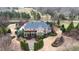 Aerial view shows property and neighborhood including private drive and landscaping at 212 Whirlaway Ln, Chapel Hill, NC 27516