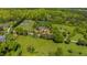 Expansive aerial view featuring several homes situated on large green lawns with mature trees at 212 Whirlaway Ln, Chapel Hill, NC 27516