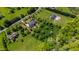 Gorgeous aerial view of a luxury home with well-manicured landscaping and a private pool at 212 Whirlaway Ln, Chapel Hill, NC 27516
