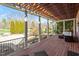 Back porch featuring wood decking, pillars, and outdoor seating at 212 Whirlaway Ln, Chapel Hill, NC 27516