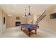 Spacious basement featuring a billiards table, fireplace, and stairway at 212 Whirlaway Ln, Chapel Hill, NC 27516