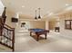 Spacious basement featuring a billiards table, and stairway at 212 Whirlaway Ln, Chapel Hill, NC 27516