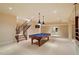Spacious basement featuring a billiards table, and stairway at 212 Whirlaway Ln, Chapel Hill, NC 27516