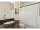 Bathroom features a granite countertop, bronze fixtures, and white shower curtain at 212 Whirlaway Ln, Chapel Hill, NC 27516