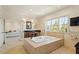 Bright bathroom featuring soaking tub, tiled floors, and a large window offering great views at 212 Whirlaway Ln, Chapel Hill, NC 27516