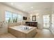 Bathroom features large tub, dark wood vanity, and picture window at 212 Whirlaway Ln, Chapel Hill, NC 27516