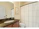 Bathroom features a granite countertop, bronze fixtures, and white shower curtain at 212 Whirlaway Ln, Chapel Hill, NC 27516