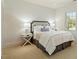 Bedroom featuring plush carpet, a large window, and simple yet elegant decor at 212 Whirlaway Ln, Chapel Hill, NC 27516