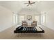 Spacious bedroom offers vaulted ceiling, recessed lights, neutral carpeting, and two lounge chairs at 212 Whirlaway Ln, Chapel Hill, NC 27516