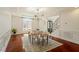 Formal dining room featuring elegant wainscoting, modern lighting and hardwood floors at 212 Whirlaway Ln, Chapel Hill, NC 27516