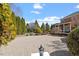 Circular driveway to home featuring brick pavers and extensive landscaping at 212 Whirlaway Ln, Chapel Hill, NC 27516