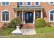Elegant home entrance featuring double doors, round windows, and detailed trim at 212 Whirlaway Ln, Chapel Hill, NC 27516