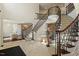 A grand foyer features dual staircases, elegant iron railings, and a marble floor at 212 Whirlaway Ln, Chapel Hill, NC 27516