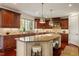 Gourmet kitchen featuring custom cabinets, stainless steel appliances, large center island, and stone countertops at 212 Whirlaway Ln, Chapel Hill, NC 27516