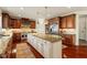Gourmet kitchen featuring custom cabinets, stainless steel appliances, large center island, and stone countertops at 212 Whirlaway Ln, Chapel Hill, NC 27516