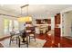 Spacious kitchen and breakfast nook boasting custom cabinetry, stainless appliances, and french doors at 212 Whirlaway Ln, Chapel Hill, NC 27516