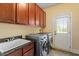 Laundry room features washer/dryer, sink, and plentiful cabinetry at 212 Whirlaway Ln, Chapel Hill, NC 27516