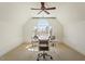 Bright office space with plush carpeting, large arched window, and desk with office chair at 212 Whirlaway Ln, Chapel Hill, NC 27516