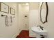 Charming powder room featuring hardwood floors, pedestal sink, framed mirror, and classic fixtures at 212 Whirlaway Ln, Chapel Hill, NC 27516