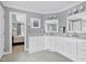 Bright bathroom features white cabinets, marble floors, and a view into an adjacent bedroom at 218 Whisperwood Dr, Cary, NC 27518