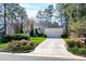 Inviting home with a clean driveway and a well-maintained lawn, surrounded by mature trees at 218 Whisperwood Dr, Cary, NC 27518