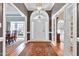 Elegant foyer with hardwood floors, arched doorway, and access to both dining and living areas at 218 Whisperwood Dr, Cary, NC 27518