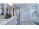 Modern bathroom with a double vanity, walk-in shower with a bench, and sleek fixtures at 230 Tidal Pool Way, Cary, NC 27519