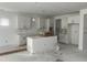 Unfinished kitchen featuring white cabinets, a central island, and awaiting appliances, offering a customizable space at 230 Tidal Pool Way, Cary, NC 27519