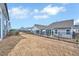 Fenced backyard with a view of neighboring houses and mature trees, perfect for outdoor activities at 244 Mahogany Run, Raleigh, NC 27610