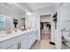 Bathroom boasting double sinks, white cabinets, a walk-in closet and a separate toilet area at 244 Mahogany Run, Raleigh, NC 27610